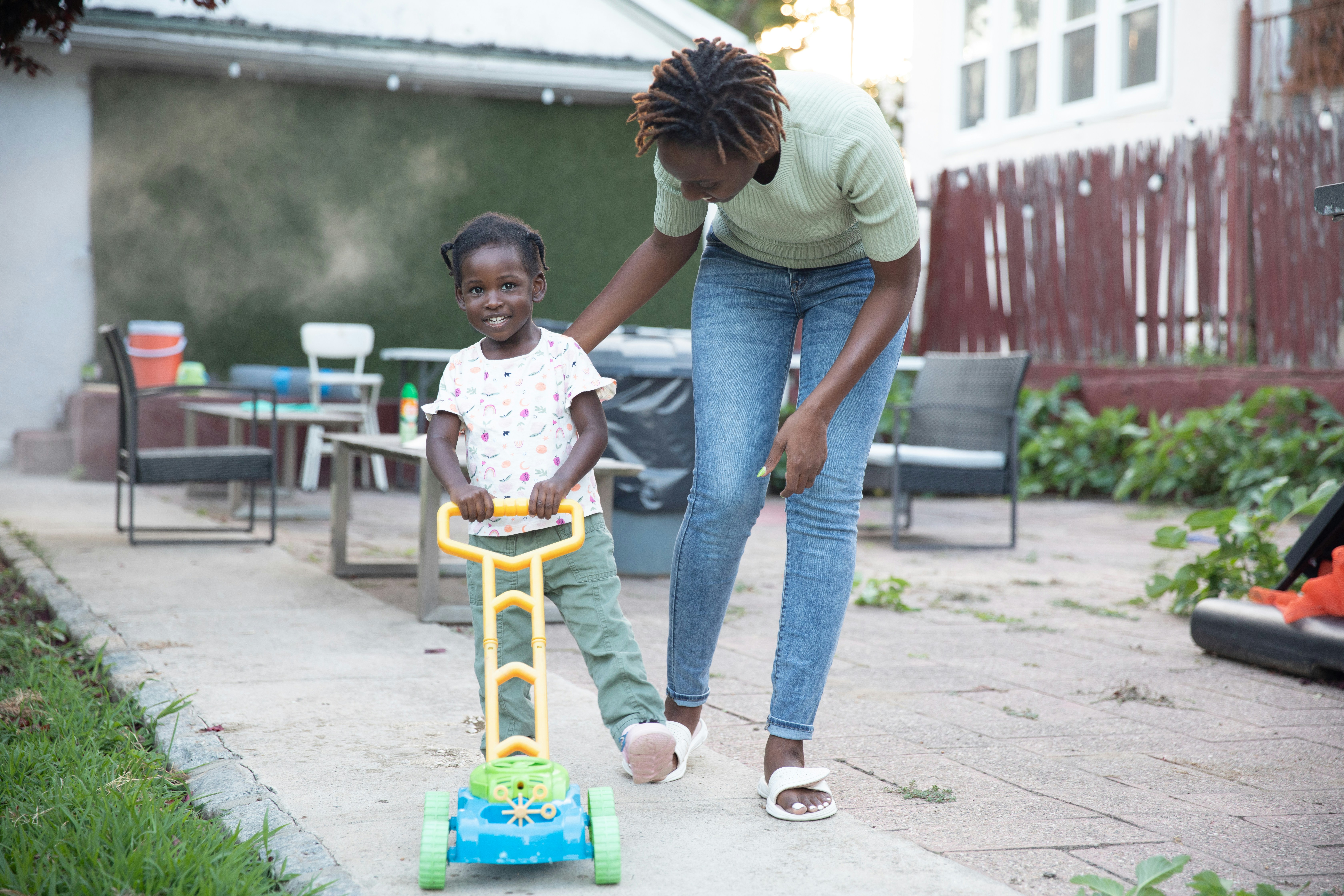 Black caregiver helping child with homework
