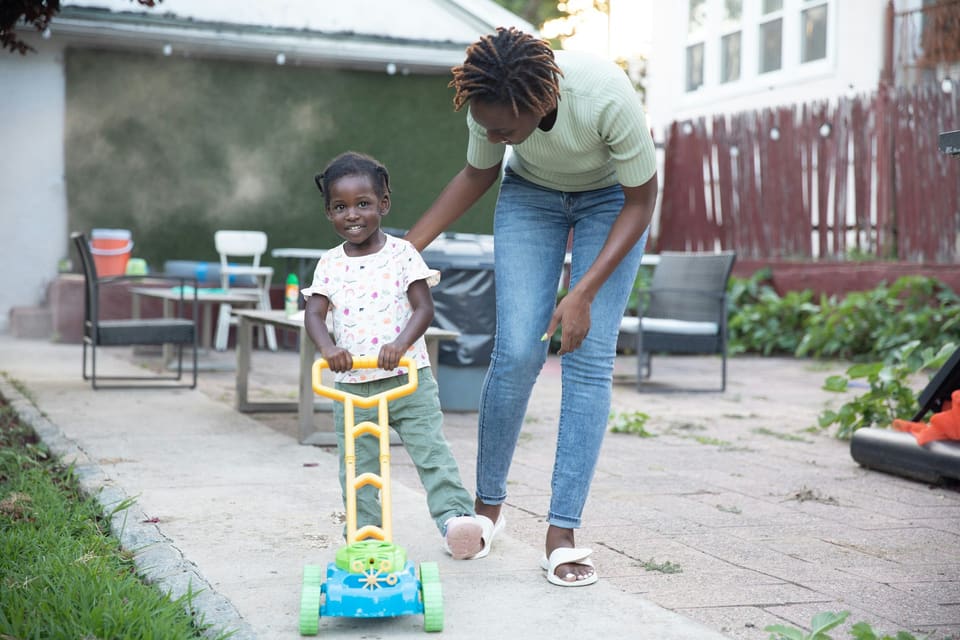 Black caregiver helping child with homework