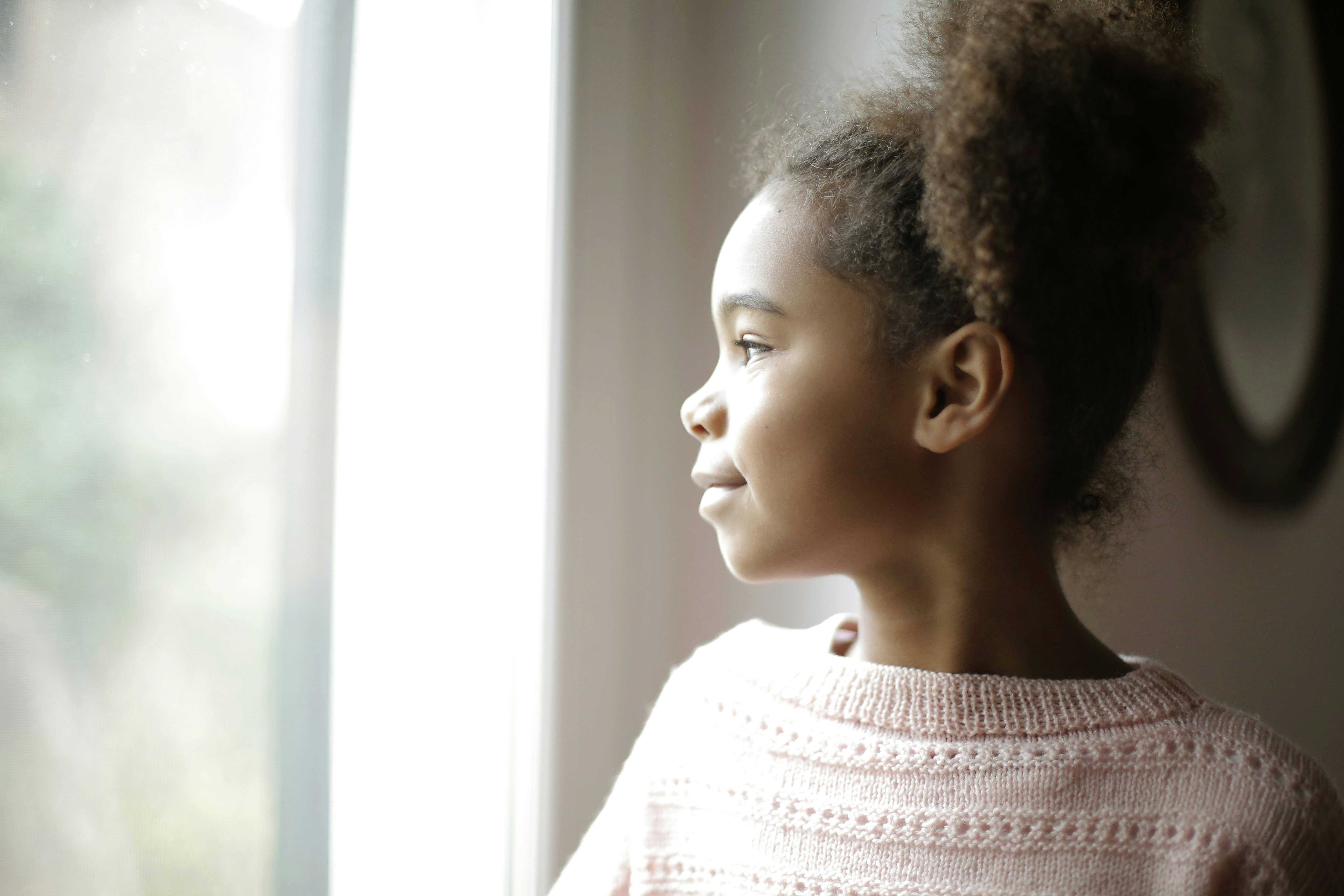 Black child counting coins and learning patience